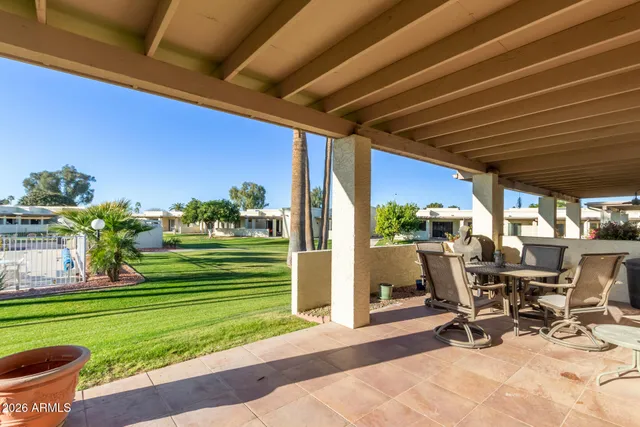 a view of a patio with table and chairs and potted plants
