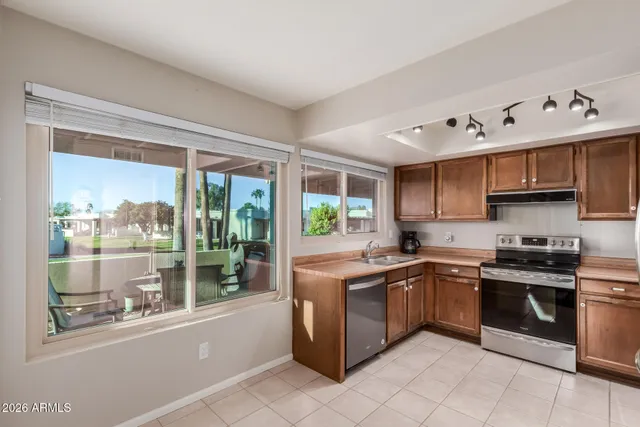 a kitchen with stainless steel appliances granite countertop a stove and a sink