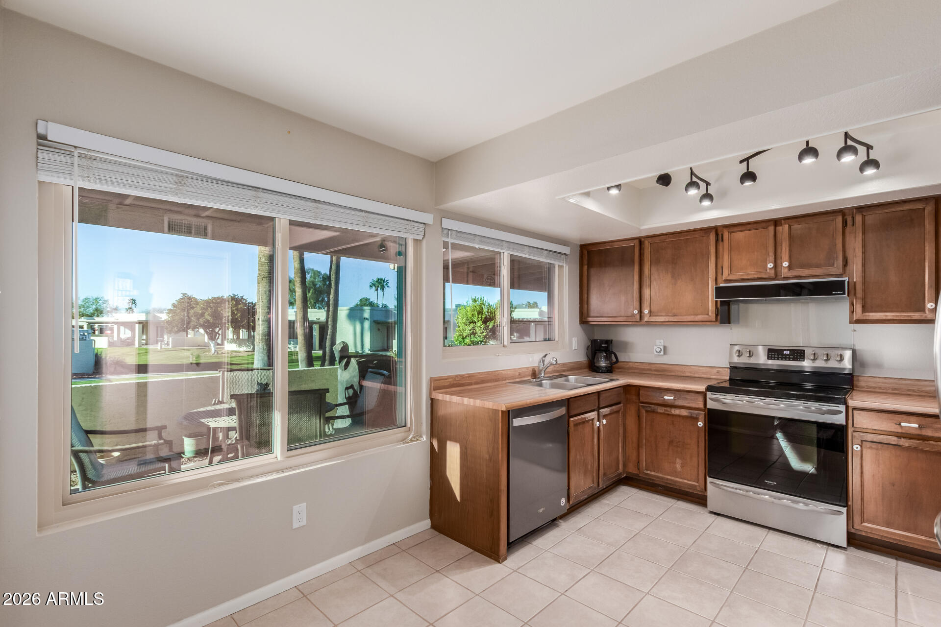 632 South 79th Way Mesa, AZ 85208 - Photo 4 of 30 a kitchen with stainless steel appliances granite countertop a stove and a sink