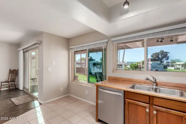a view of kitchen with sink and large window