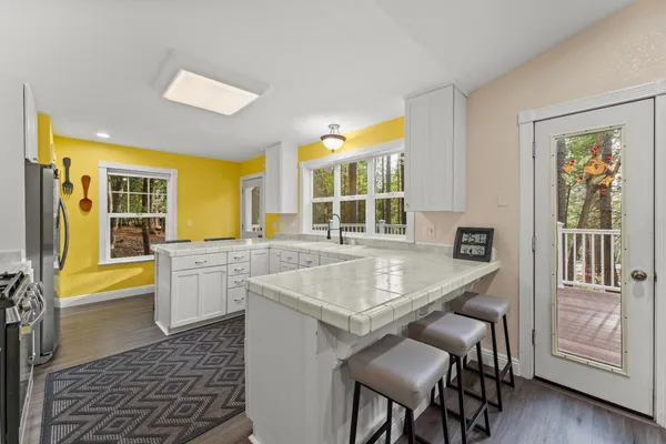 a kitchen with white cabinets and stainless steel appliances