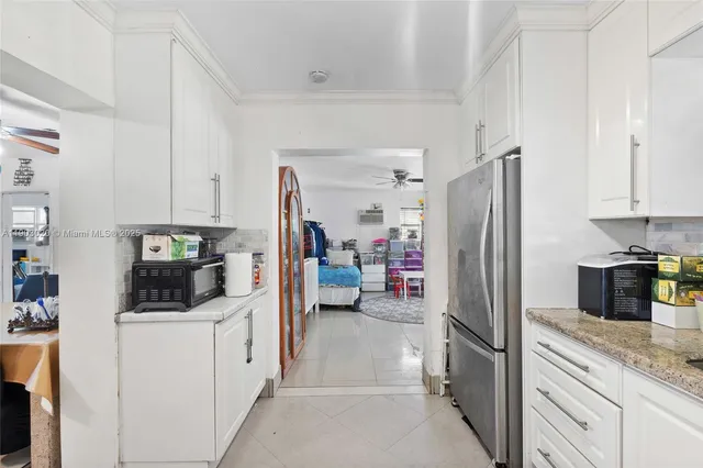 a kitchen with refrigerator and cabinets