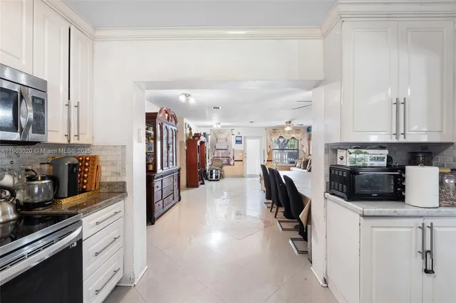 a kitchen with refrigerator and cabinets