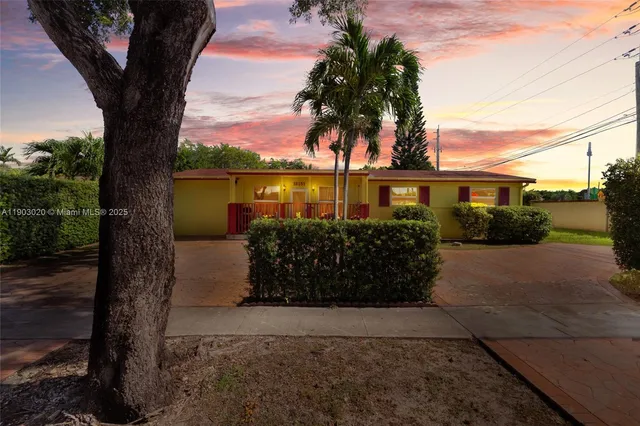 a view of a lake with a tree next to yard