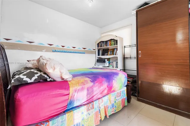 a bedroom with a bed and a book shelf