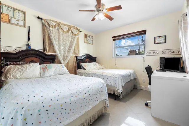 a bedroom with two beds and a chandelier