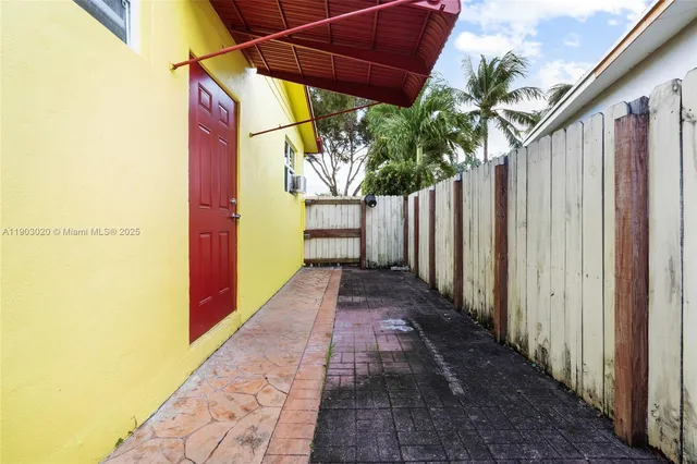 a view of a pathway with a backyard