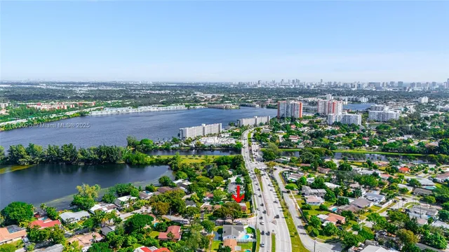 an aerial view of a house with a lake view