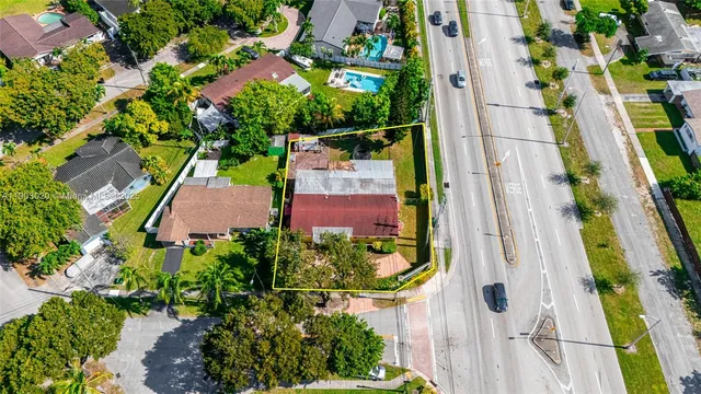an aerial view of a house with a yard