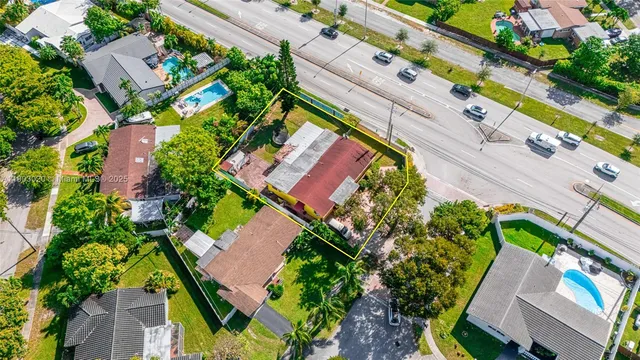 an aerial view of a house with a yard and garden
