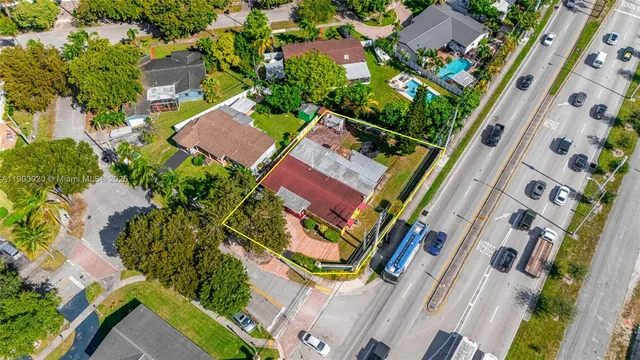 an aerial view of residential houses with yard and outdoor space
