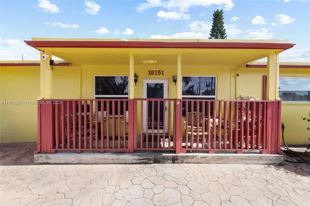 a view of a house with wooden fence