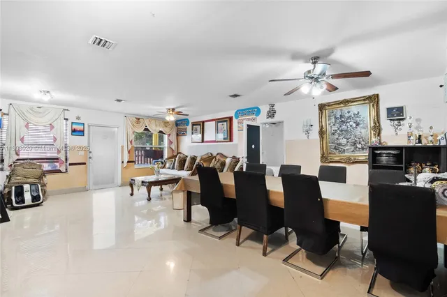 a living room with lots of furniture and kitchen view