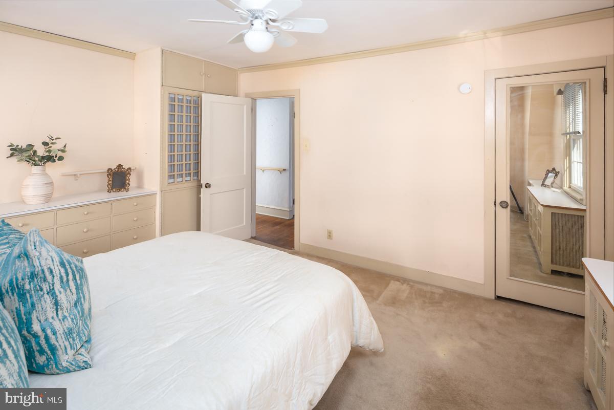 120 Crosshill Road Wynnewood, PA 19096 - Photo 18 of 29 a spacious bedroom with a bed and a chandelier