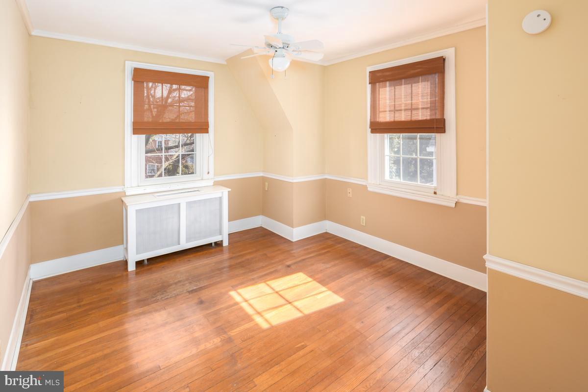 120 Crosshill Road Wynnewood, PA 19096 - Photo 19 of 29 a view of an empty room with a window and wooden floor