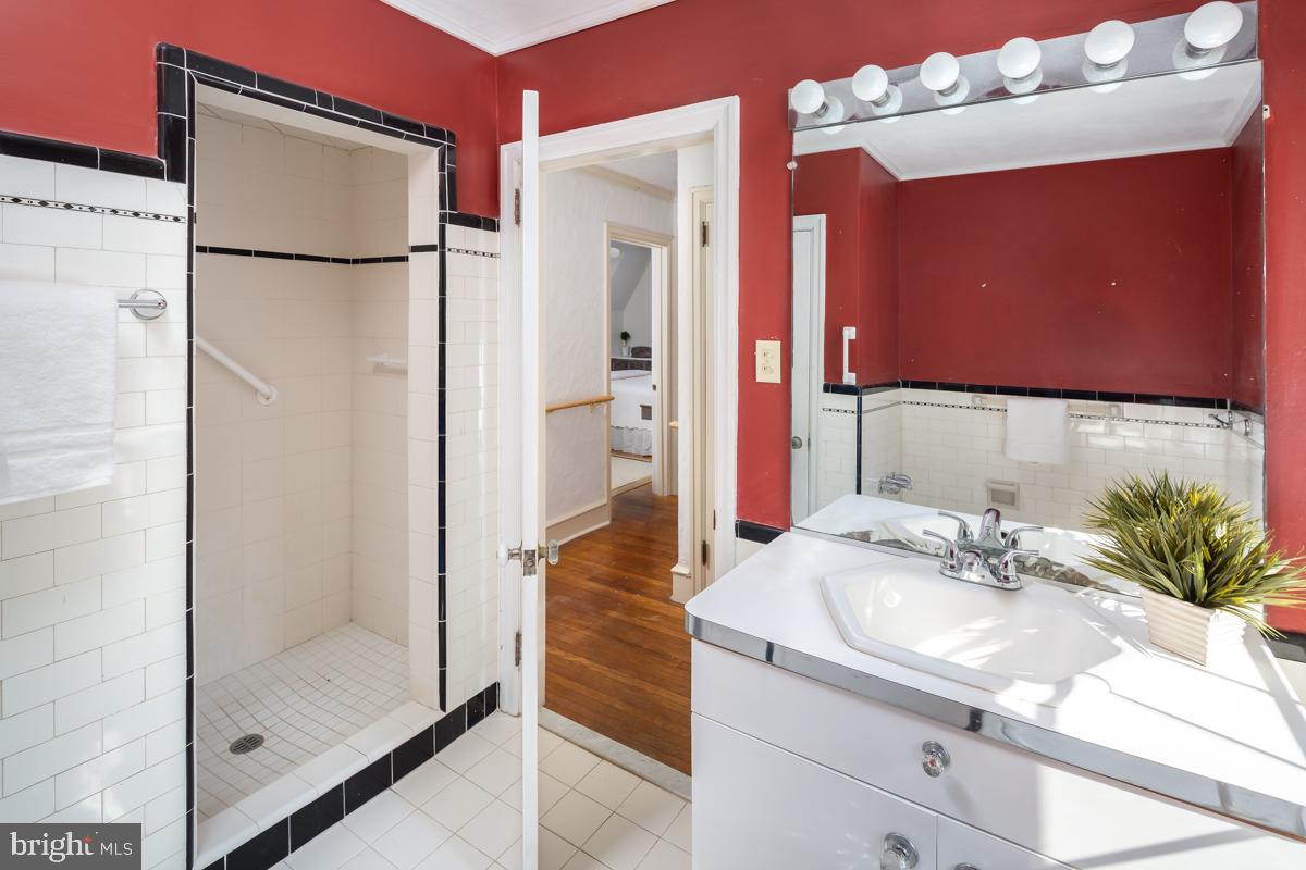 120 Crosshill Road Wynnewood, PA 19096 - Photo 22 of 29 a bathroom with a sink a mirror and a shower
