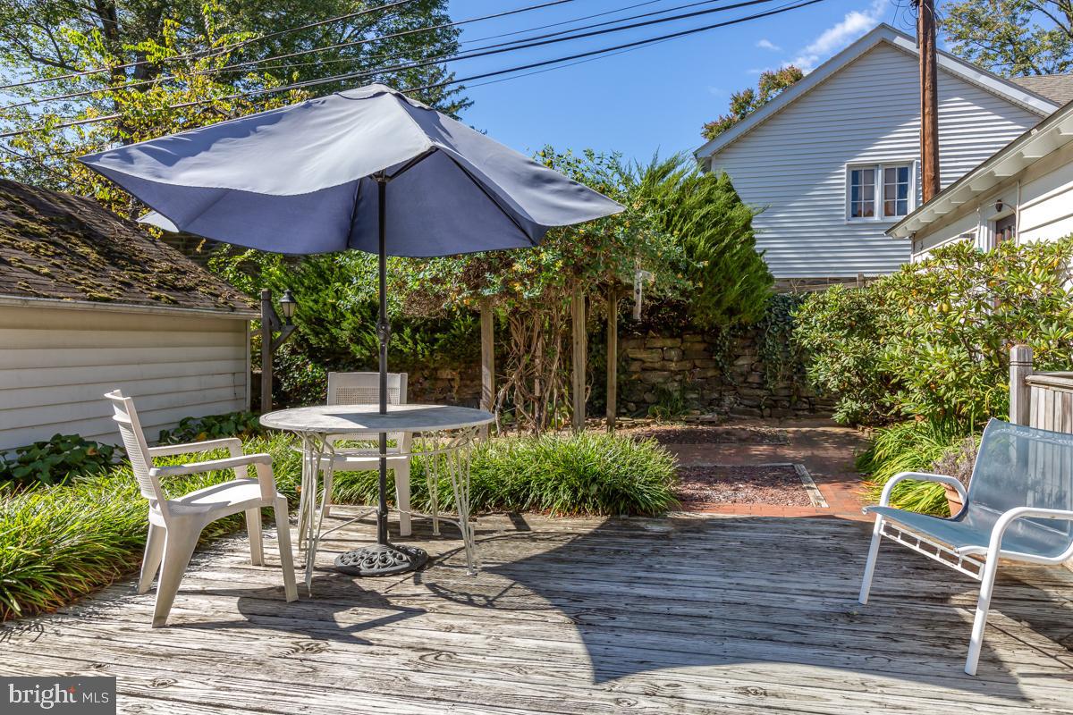 120 Crosshill Road Wynnewood, PA 19096 - Photo 26 of 29 a view of a patio with table and chairs under an umbrella