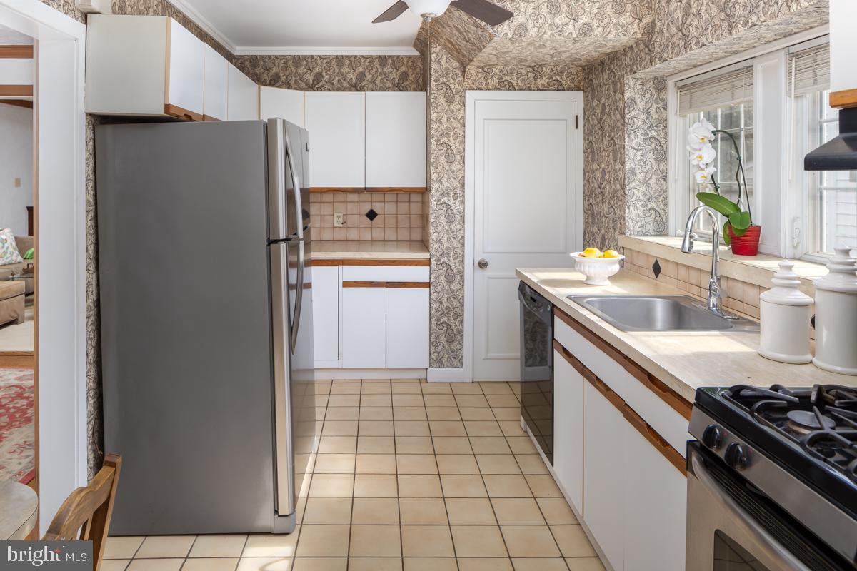 120 Crosshill Road Wynnewood, PA 19096 - Photo 10 of 29 a kitchen with a sink a stove and refrigerator