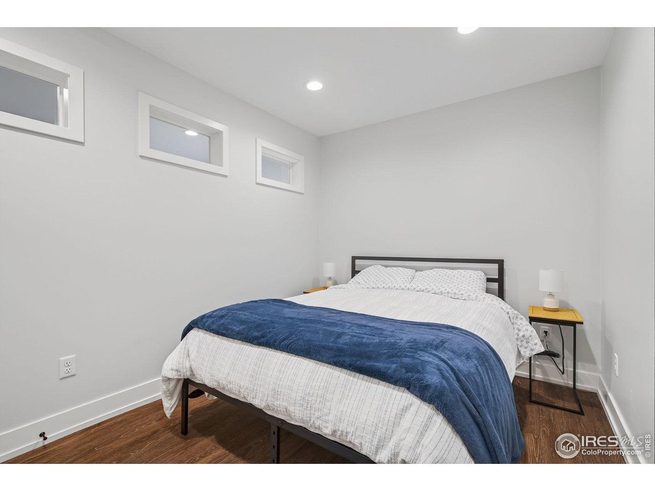 1719 Mapleton Avenue Boulder, CO 80304 - Photo 38 of 50 a bedroom with a bed and a lamp on dresser