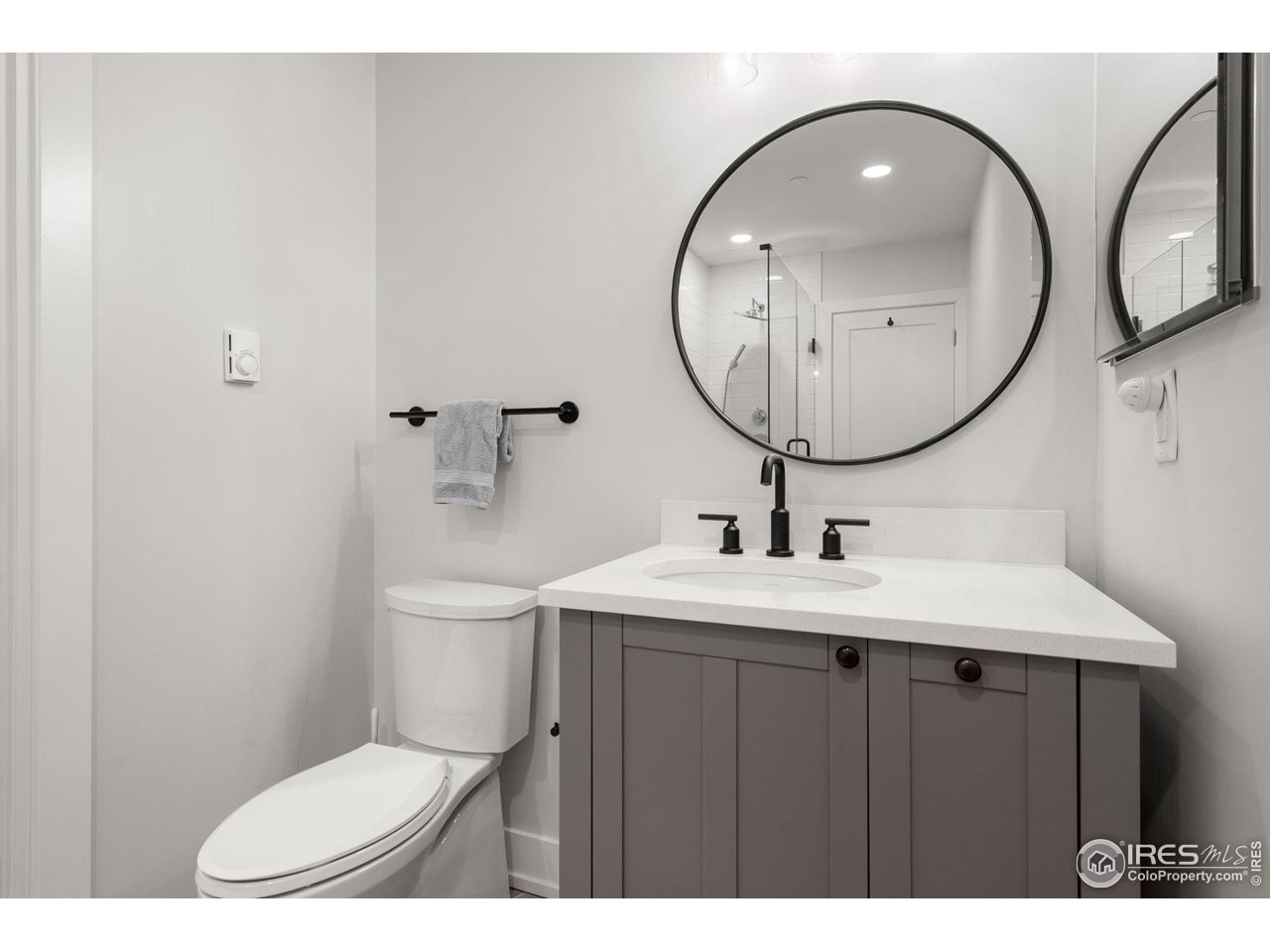 1719 Mapleton Avenue Boulder, CO 80304 - Photo 39 of 50 a bathroom with a toilet a sink and a mirror