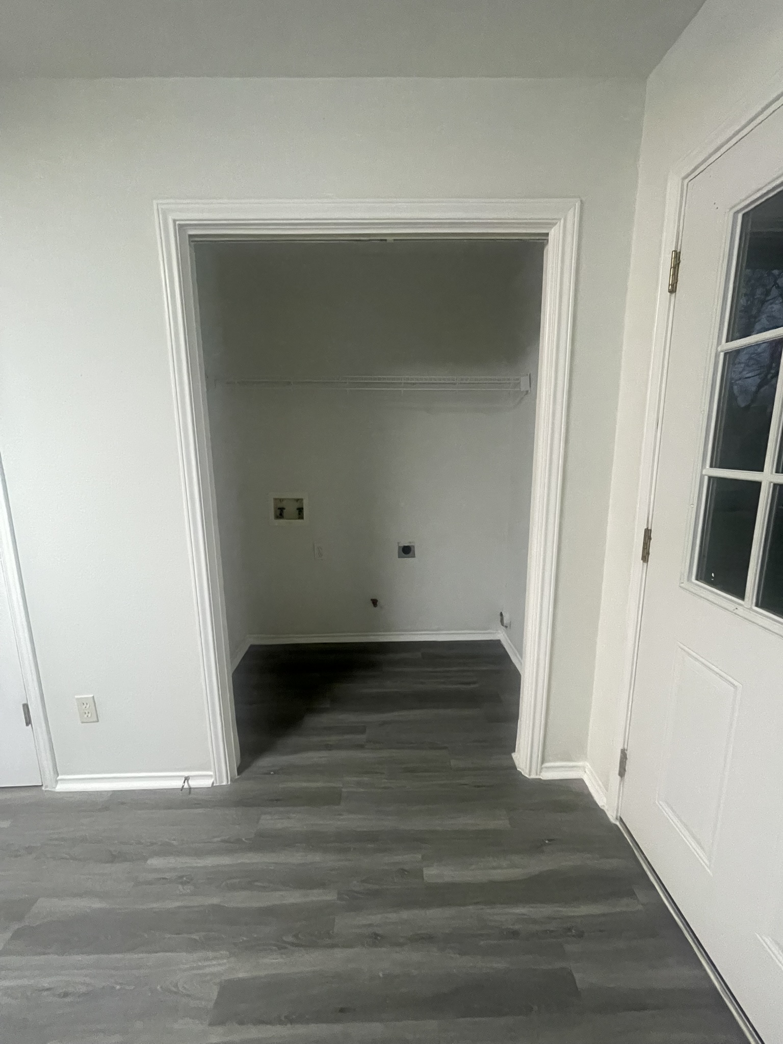 221 Britni Loop Kyle, TX 78640 - Photo 13 of 20 Laundry area with dark wood-style floors and hookup for an electric dryer