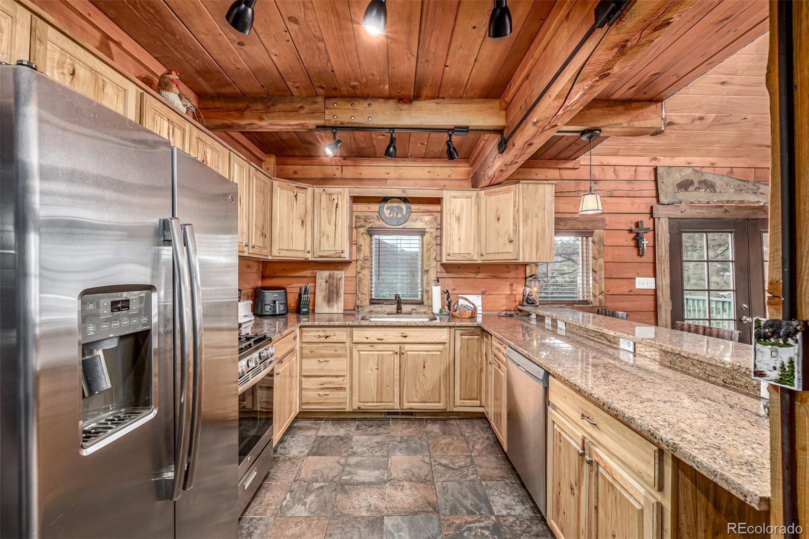 116 Dakota Path Lake George, CO 80827 - Photo 16 of 38 a kitchen with stainless steel appliances granite countertop a sink a stove top oven and refrigerator