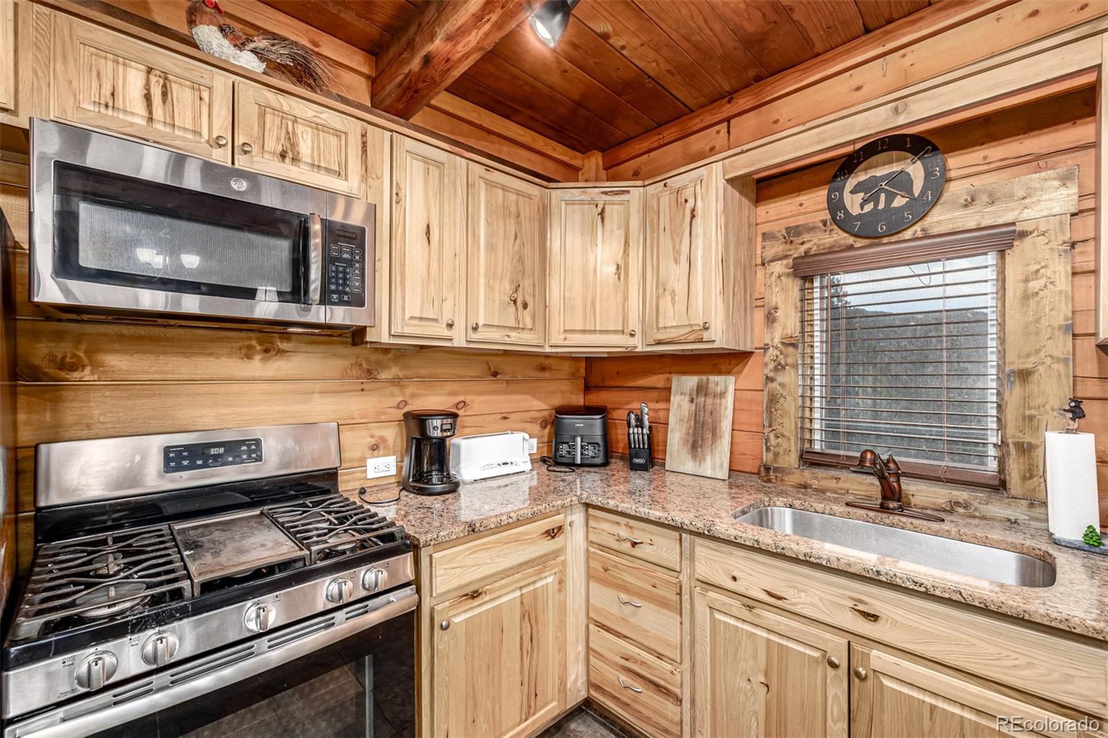 116 Dakota Path Lake George, CO 80827 - Photo 17 of 38 a kitchen with stainless steel appliances granite countertop a stove and a microwave