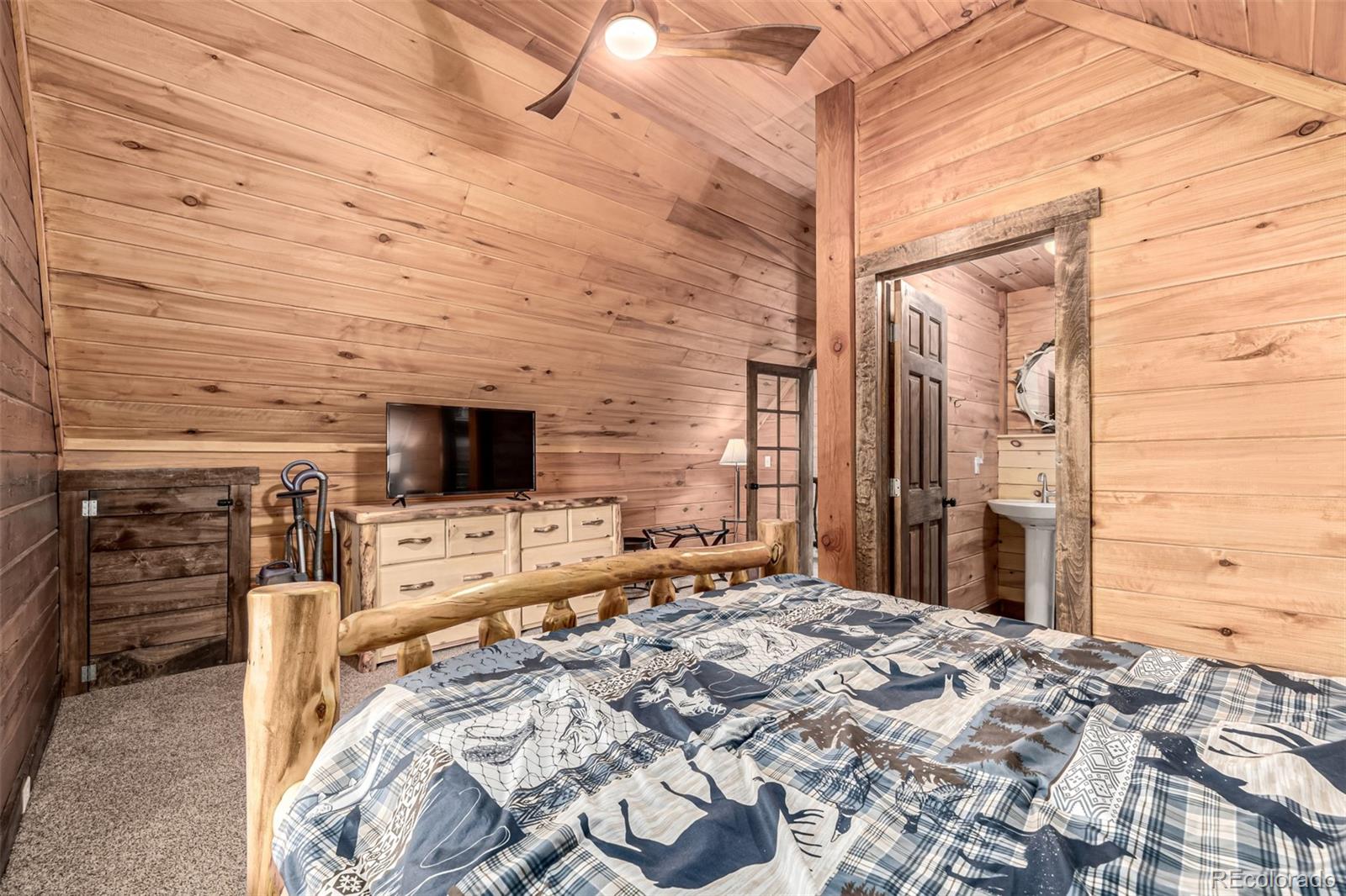 116 Dakota Path Lake George, CO 80827 - Photo 24 of 38 a bed room with a bed and a television