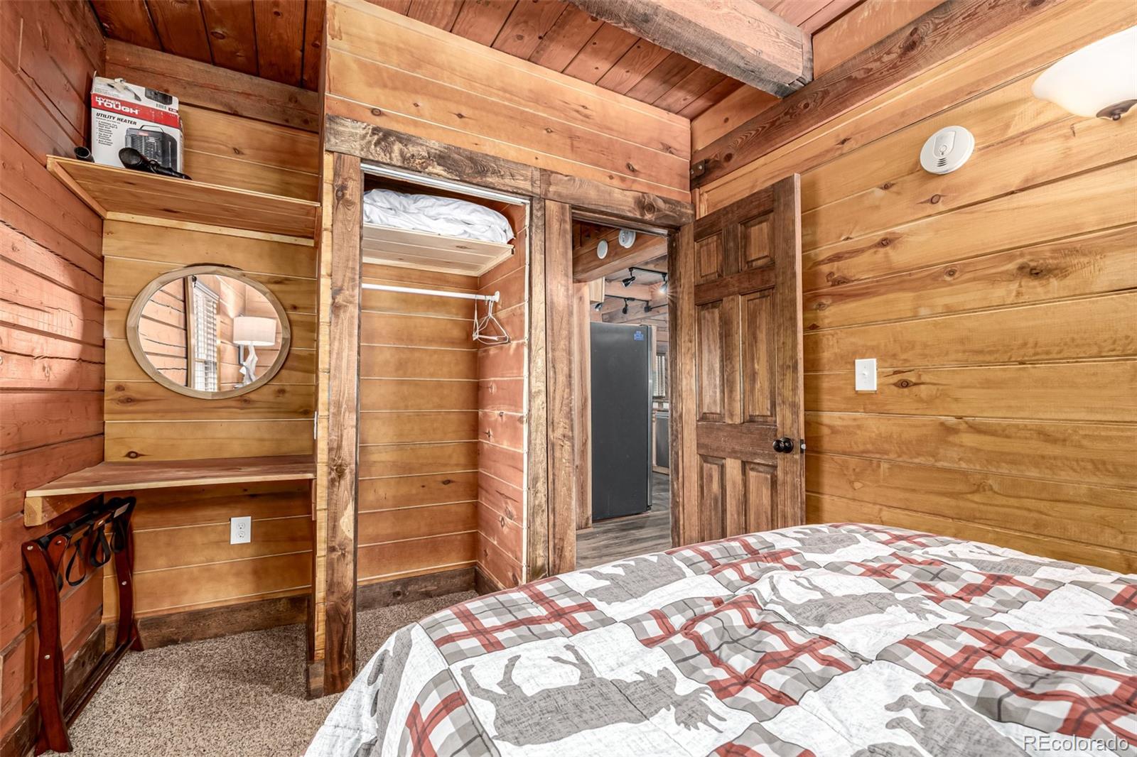 116 Dakota Path Lake George, CO 80827 - Photo 27 of 38 a bedroom with a bed and a chandelier