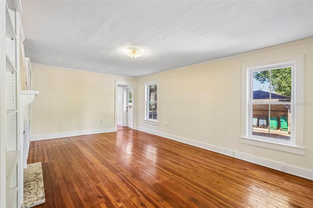 1190 Old Mt Dora Road Eustis, FL 32726 - Photo 11 of 69 a view of an empty room with wooden floor and a window