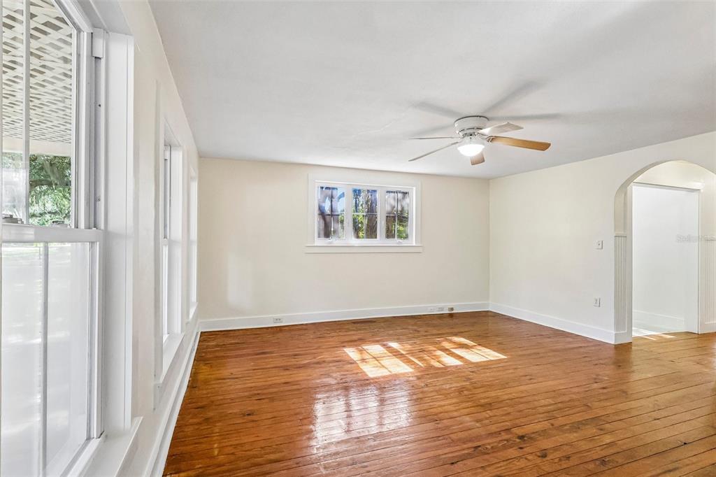 1190 Old Mt Dora Road Eustis, FL 32726 - Photo 13 of 69 a view of a big room with wooden floor and windows in a room