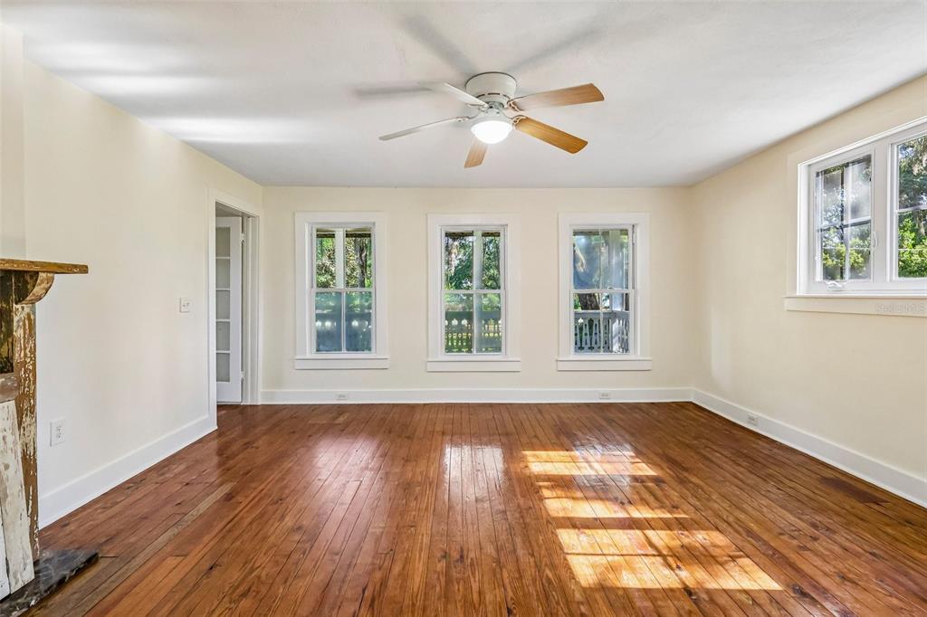 1190 Old Mt Dora Road Eustis, FL 32726 - Photo 15 of 69 a view of an empty room with wooden floor and a window