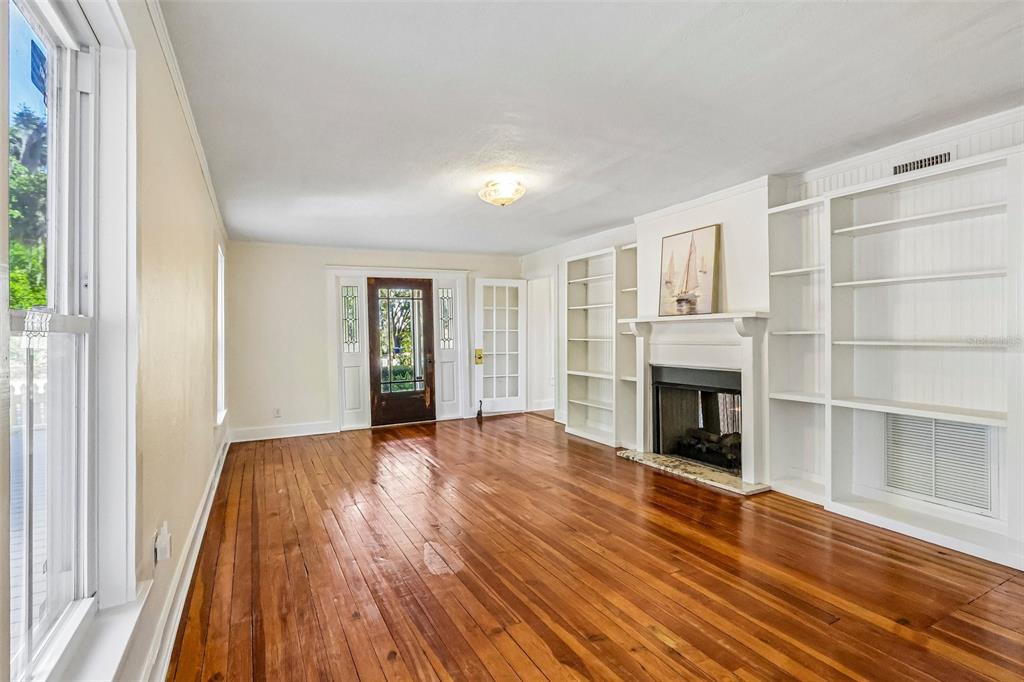 1190 Old Mt Dora Road Eustis, FL 32726 - Photo 16 of 69 a view of an empty room with wooden floor and a window
