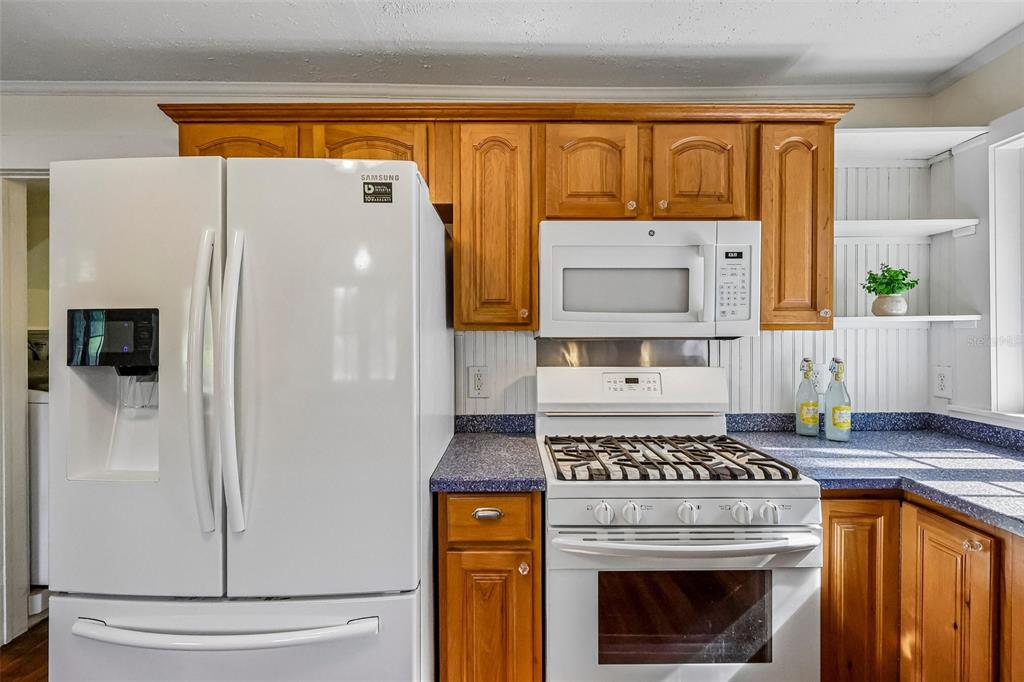 1190 Old Mt Dora Road Eustis, FL 32726 - Photo 23 of 69 a kitchen with a stove and a refrigerator