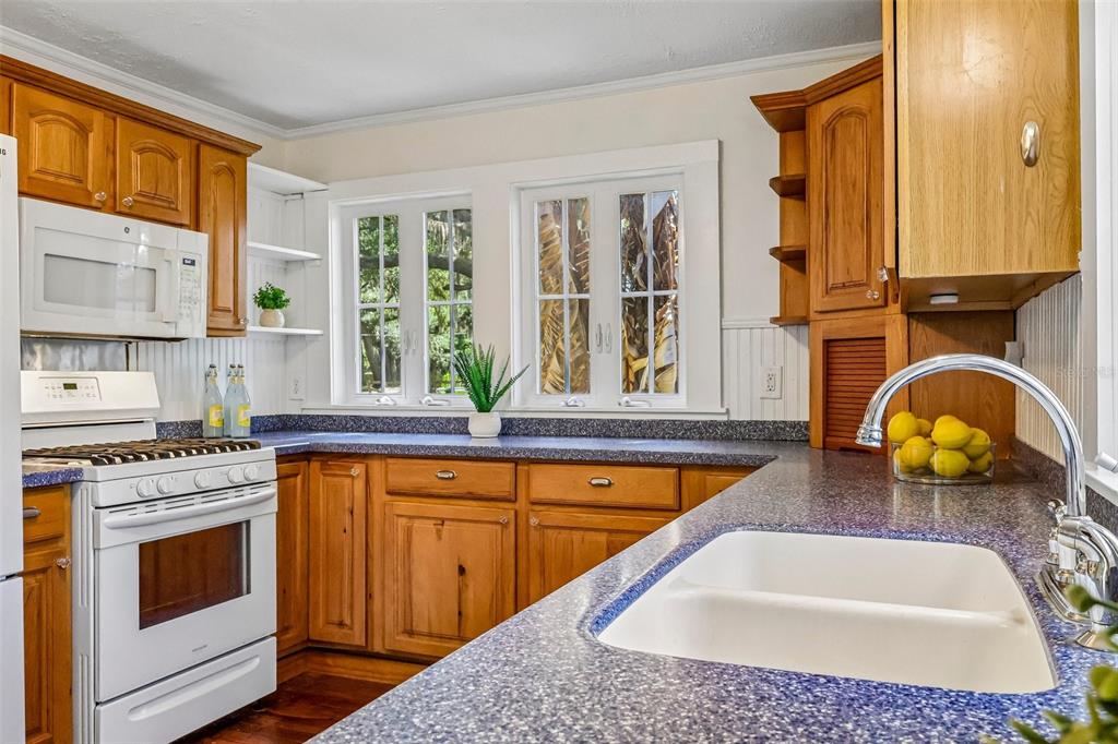 1190 Old Mt Dora Road Eustis, FL 32726 - Photo 27 of 69 a kitchen with stainless steel appliances granite countertop a sink a stove and a wooden floors