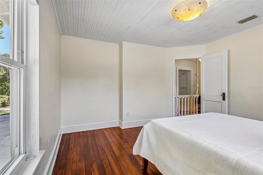 1190 Old Mt Dora Road Eustis, FL 32726 - Photo 35 of 69 a bedroom with a bed and painting on the wall