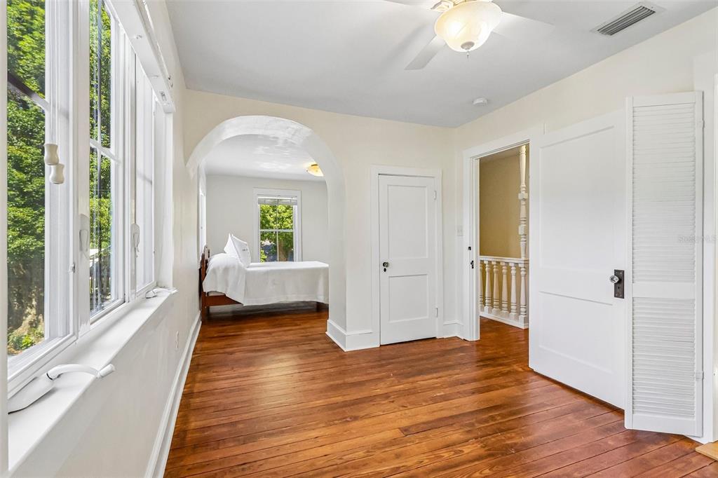 1190 Old Mt Dora Road Eustis, FL 32726 - Photo 38 of 69 a view of a bedroom with wooden floor and windows