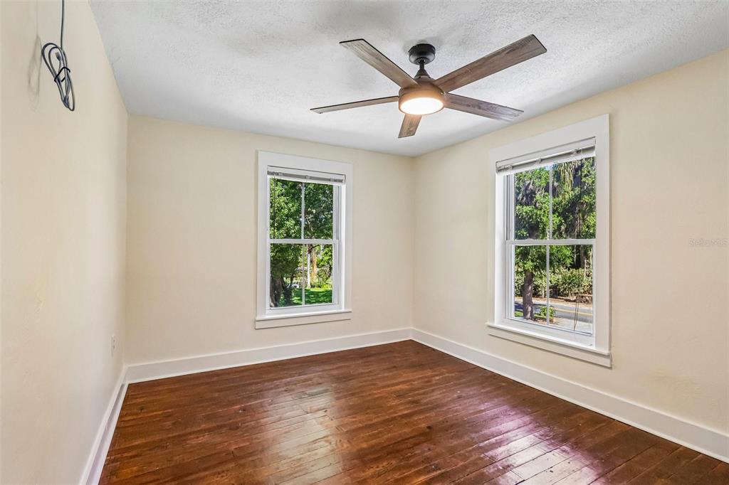 1190 Old Mt Dora Road Eustis, FL 32726 - Photo 47 of 69 a view of an empty room with wooden floor and a window