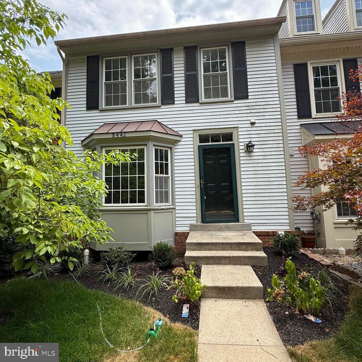 8442 Springfield Oaks Drive Springfield, VA 22153 - Photo 1 of 31 a front view of a house with garden