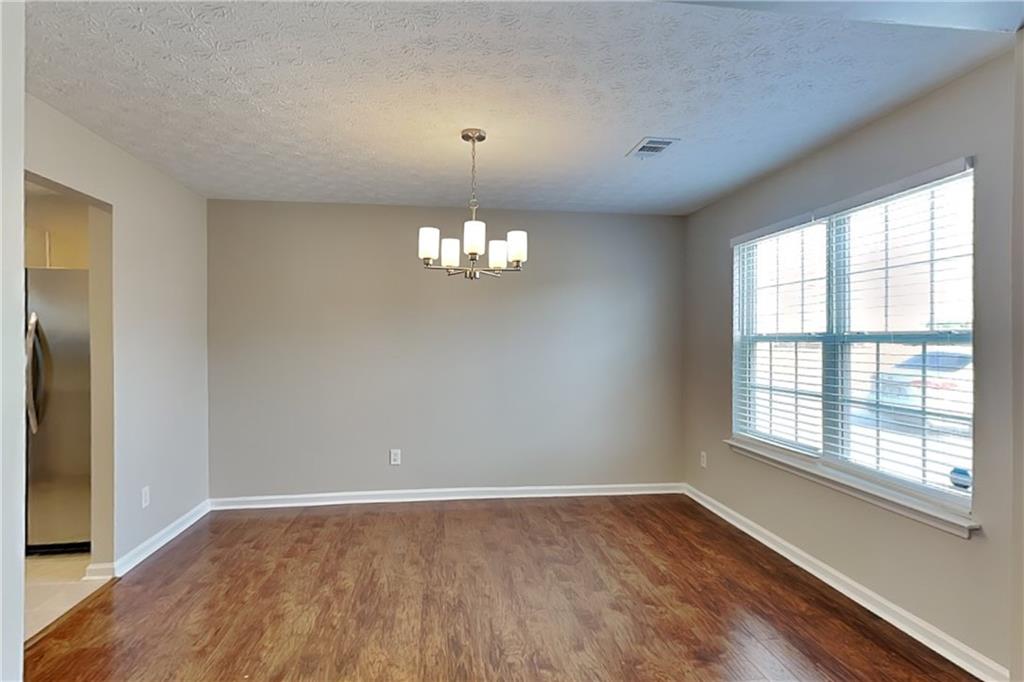 7550 Springmill Court Cumming, GA 30028 - Photo 11 of 24 wooden floor in an empty room with a window