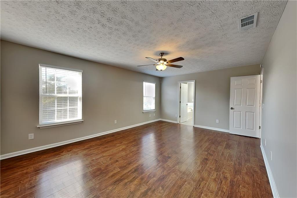 7550 Springmill Court Cumming, GA 30028 - Photo 14 of 24 wooden floor in an empty room with a window
