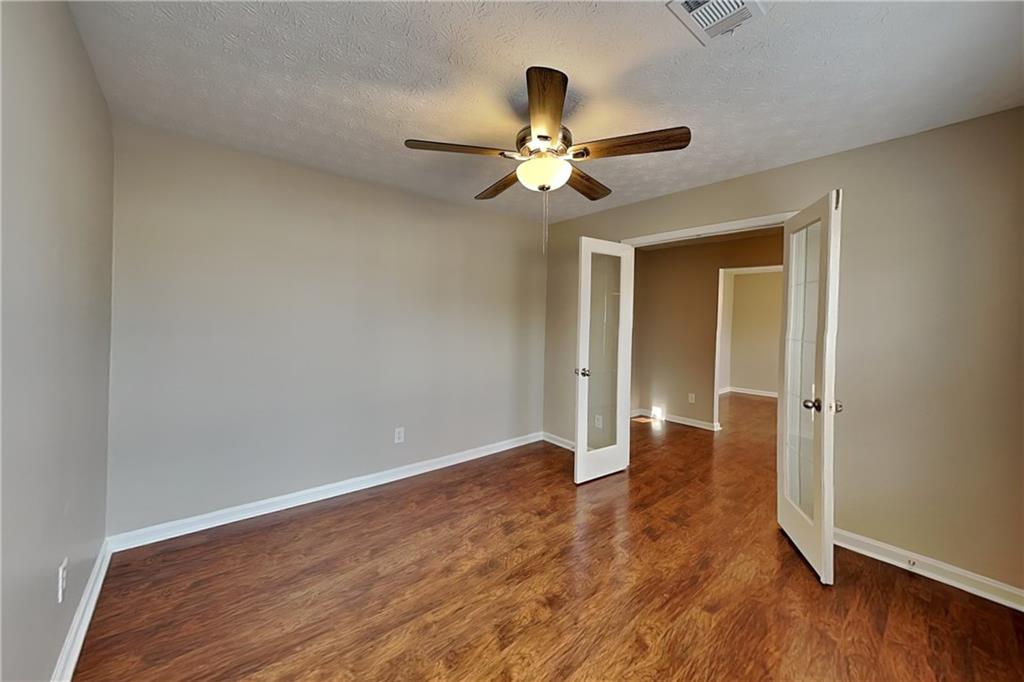 7550 Springmill Court Cumming, GA 30028 - Photo 5 of 24 a view of an empty room with wooden floor
