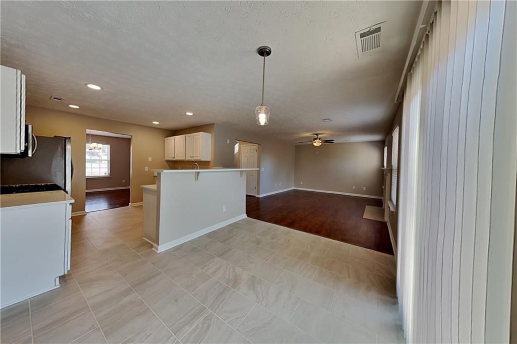 7550 Springmill Court Cumming, GA 30028 - Photo 8 of 24 a open kitchen with a refrigerator a oven and a sink