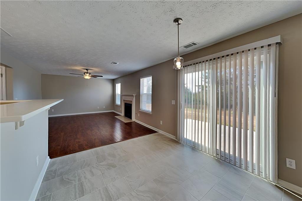 7550 Springmill Court Cumming, GA 30028 - Photo 10 of 24 a view of a livingroom with a ceiling fan and window