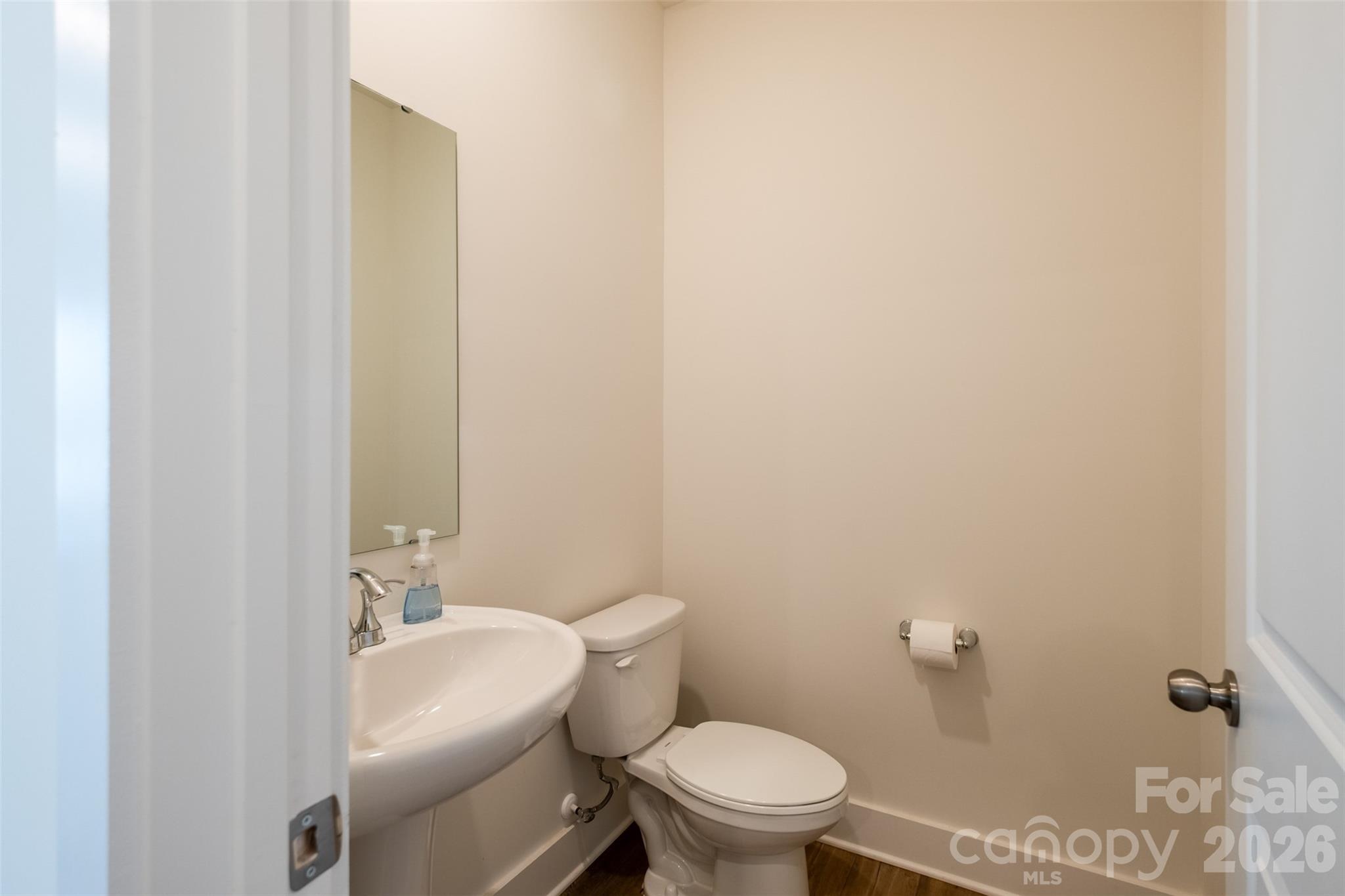 220 Sugar Hill Road Troutman, NC 28166 - Photo 17 of 37 a white toilet sitting next to a bathroom sink