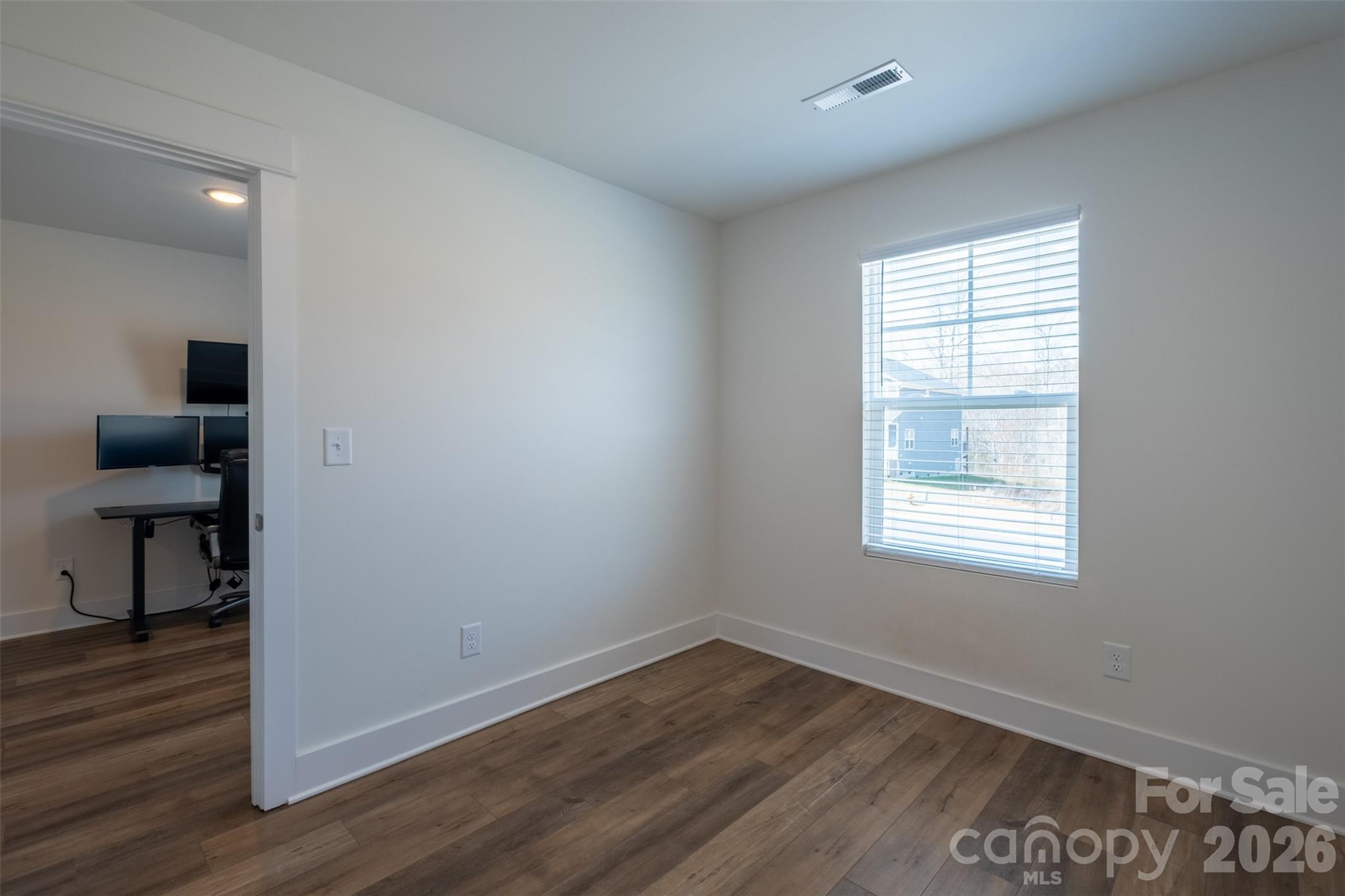 220 Sugar Hill Road Troutman, NC 28166 - Photo 20 of 37 an empty room with wooden floor and windows