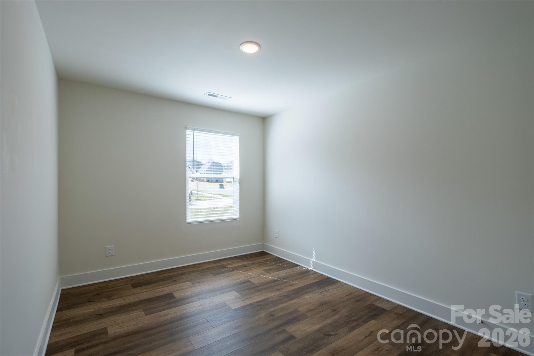 220 Sugar Hill Road Troutman, NC 28166 - Photo 23 of 37 an empty room with wooden floor and window