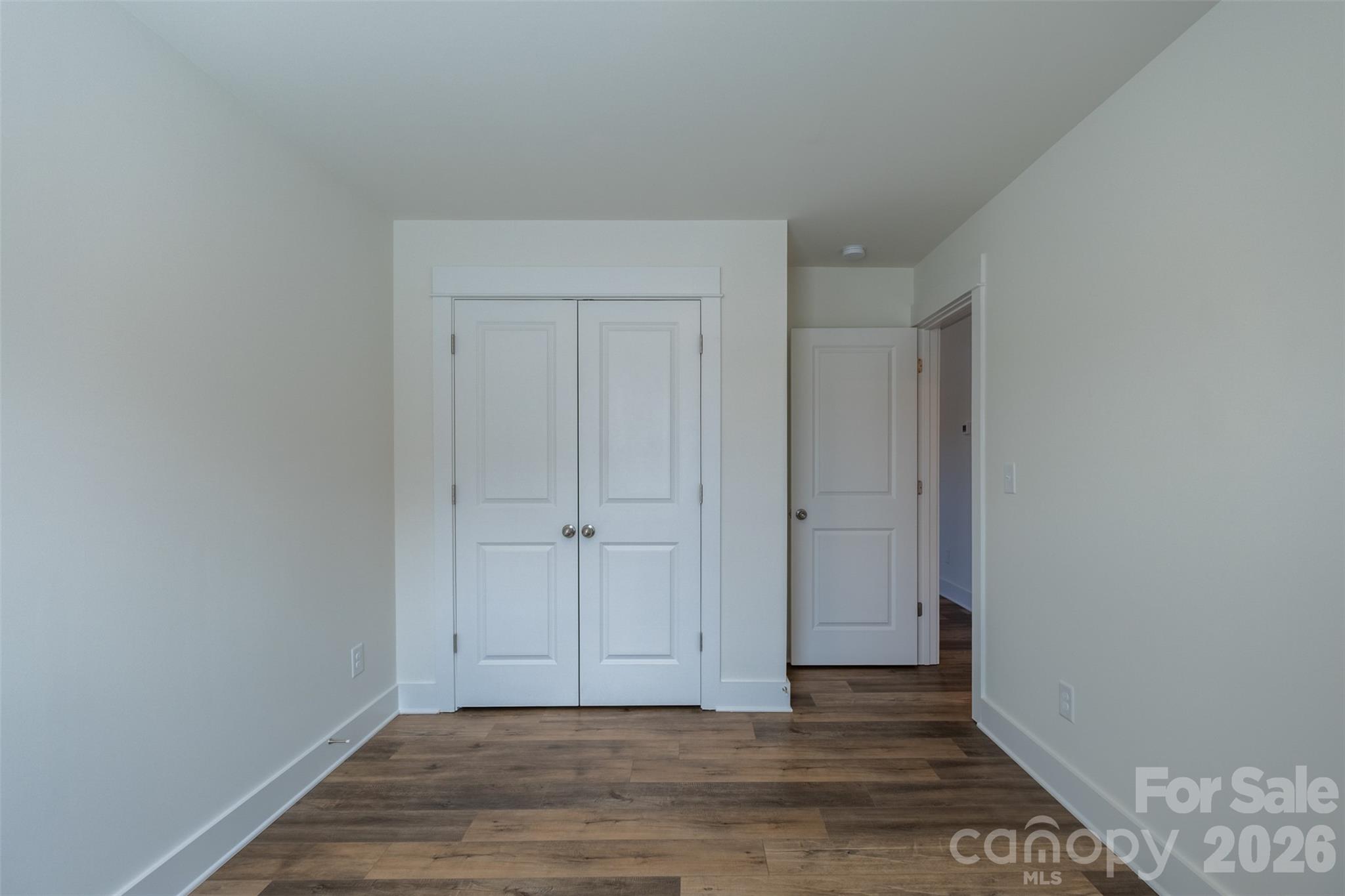 220 Sugar Hill Road Troutman, NC 28166 - Photo 24 of 37 a view of an empty room with wooden floor