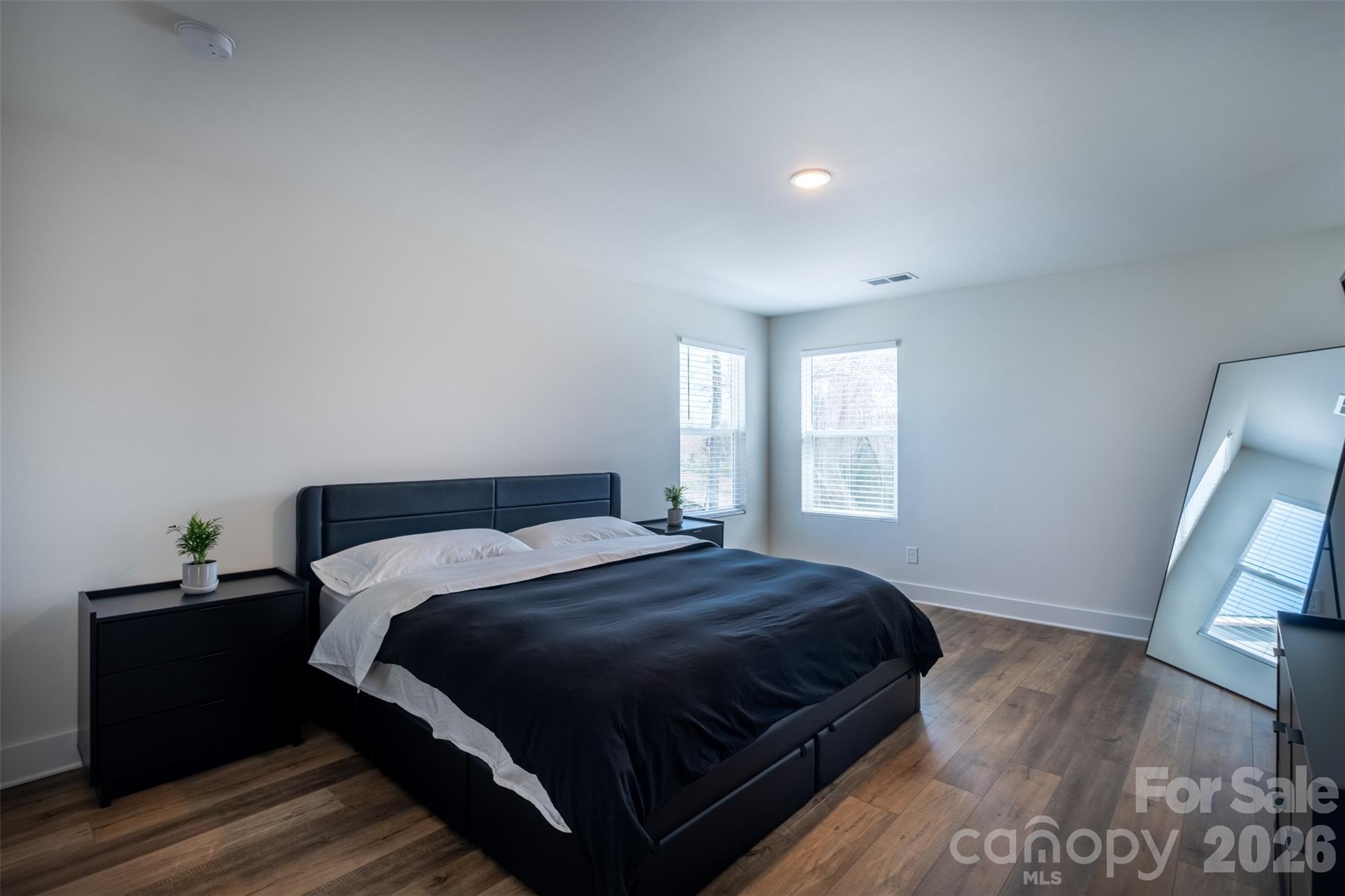 220 Sugar Hill Road Troutman, NC 28166 - Photo 30 of 37 a bedroom with a bed and wooden floor