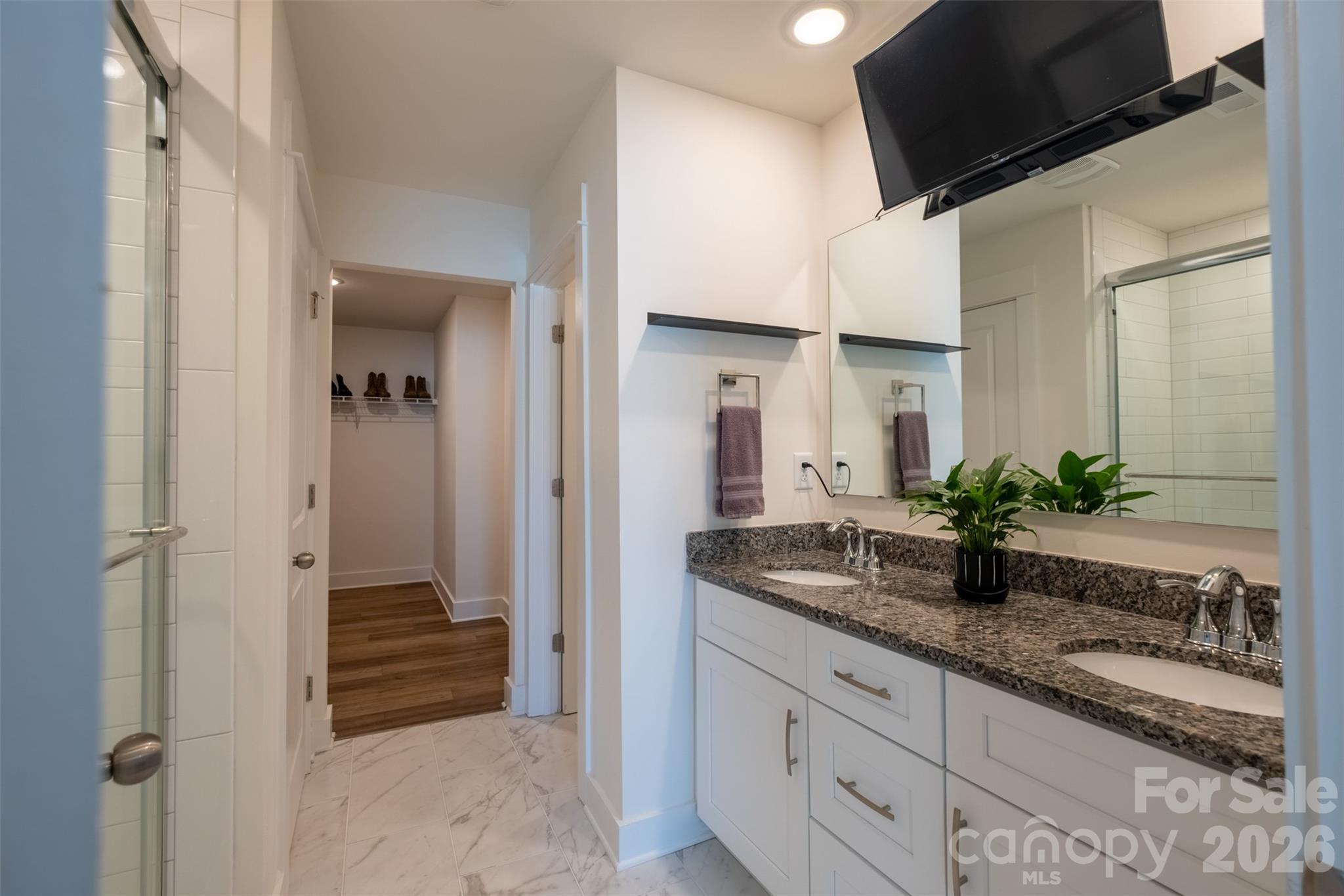 220 Sugar Hill Road Troutman, NC 28166 - Photo 32 of 37 a bathroom with a granite countertop sink and a mirror